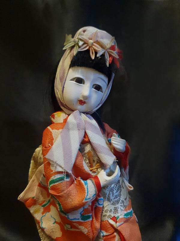 primer plano de muñeca japonesa con ojos de cristal  realizada en gofun